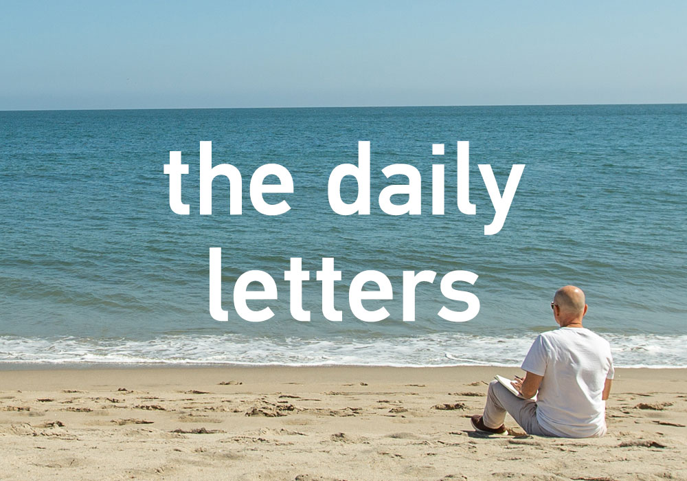 the daily letters - Alan Watt sitting in the sand at the beach